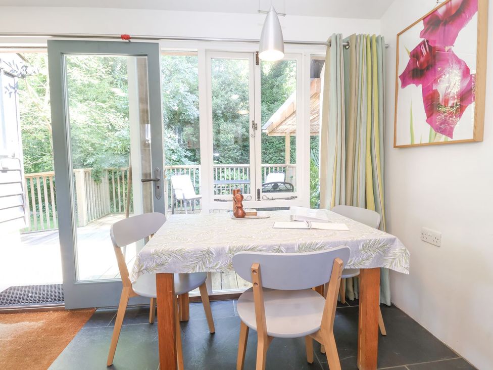 A dining room with a table and chairs at Yew Tree Farm Barn and Stable in Framlingham