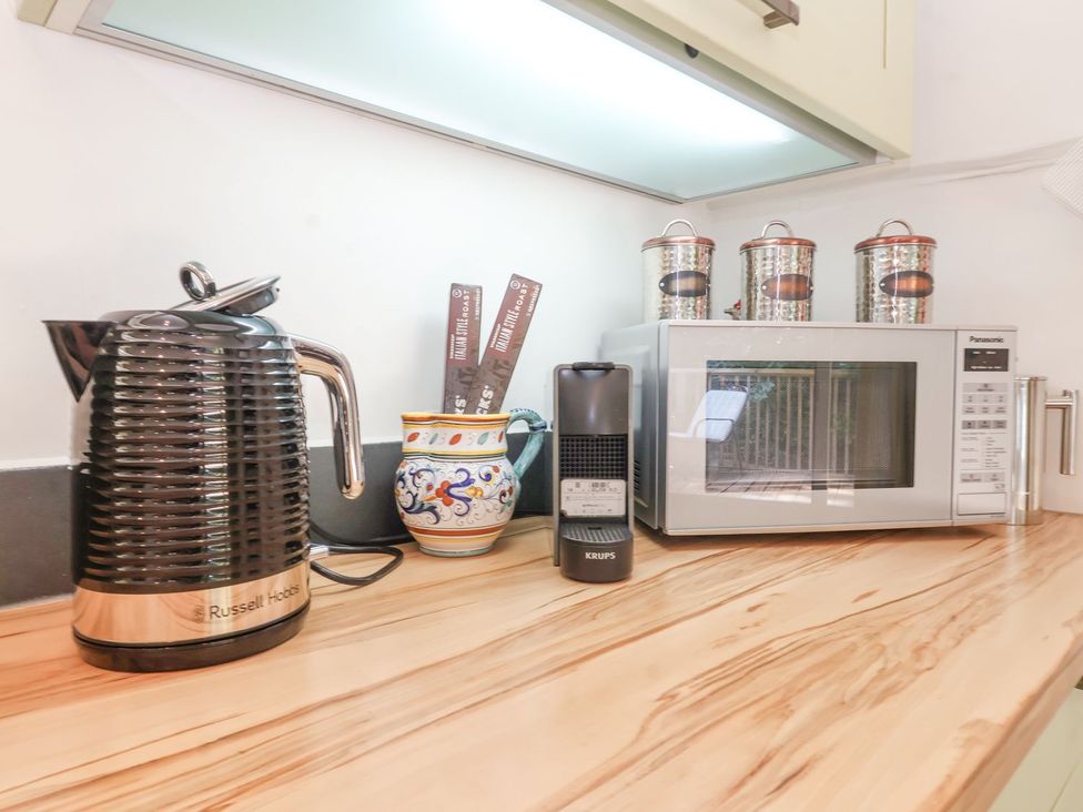 A kettle, microwave, and jars on a countertop at Yew Tree Farm Barn and Stable in Framlingham