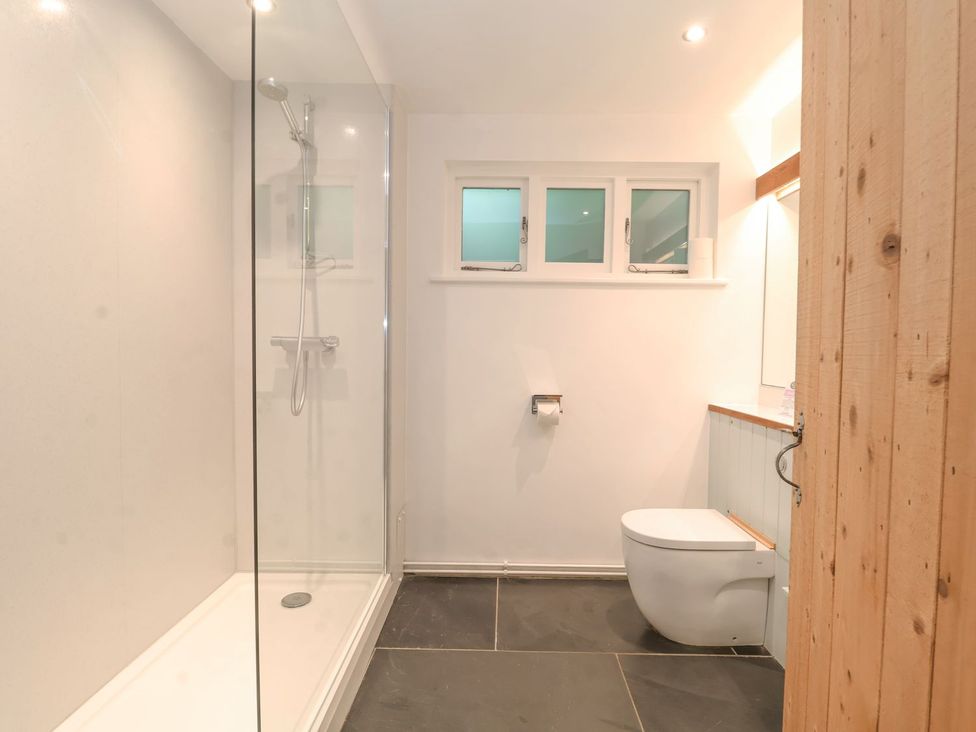 A bathroom with a shower, toilet, and sink at Yew Tree Farm Barn and Stable Framlingham