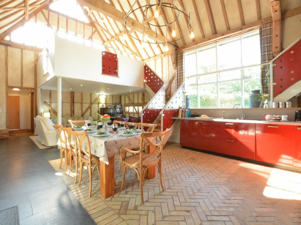 A kitchen with a dining table and chairs at Yew Tree Farm Barn and Stable Framlingham