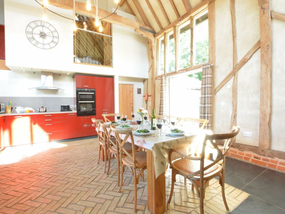A dining room with a table set for a meal at Yew Tree Farm Barn and Stable Framlingham