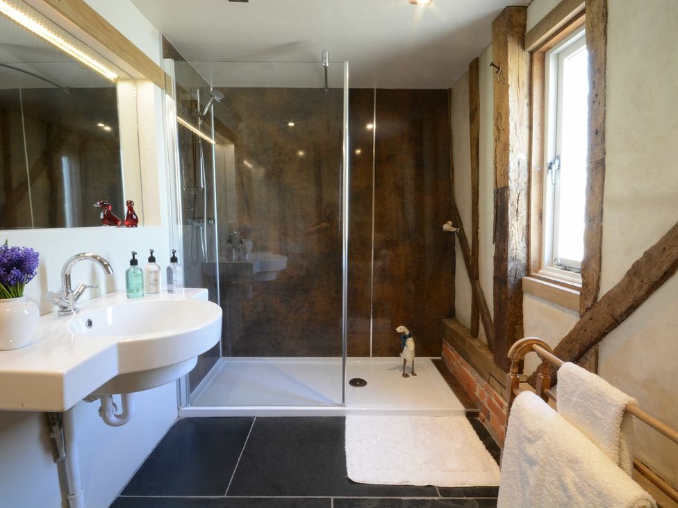 A bathroom with a shower and sink at Yew Tree Farm Barn and Stable Framlingham
