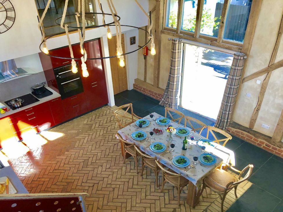 A kitchen with a dining table and chairs at Yew Tree Farm Barn and Stable in Framlingham