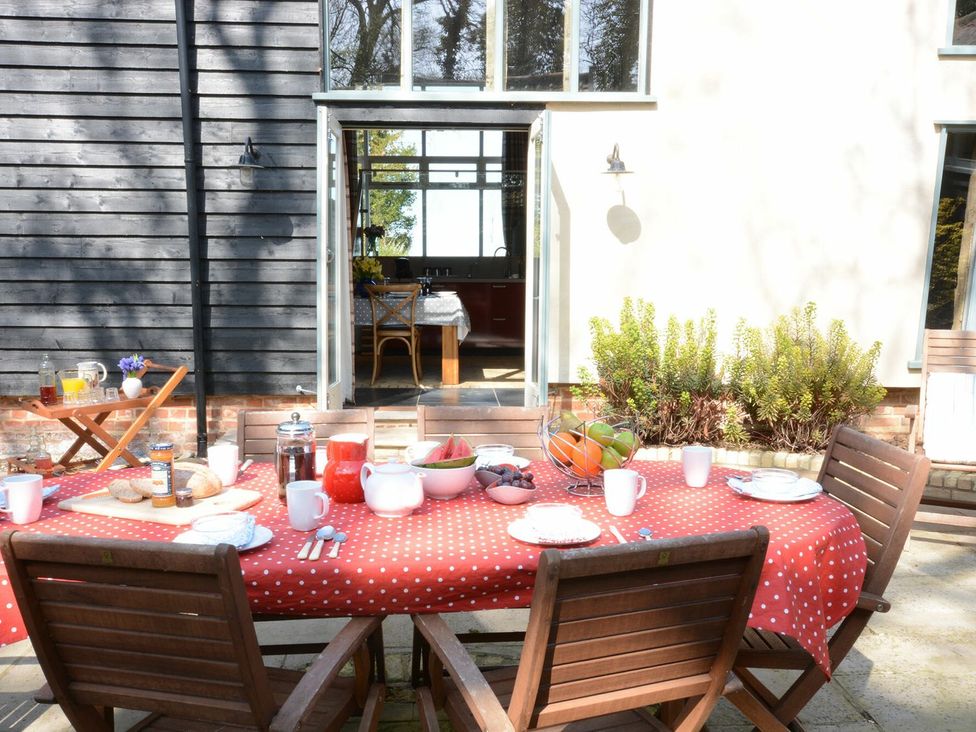 A dining table set with food and drinks outside at Yew Tree Farm Barn and Stable Framlingham