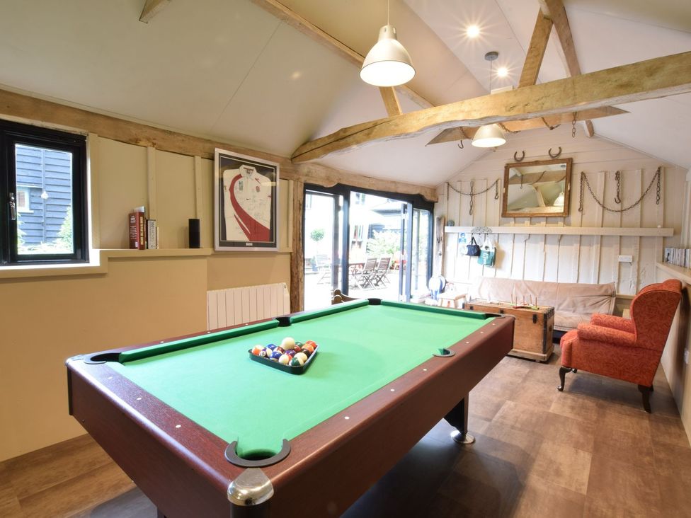 A games room with a pool table and seating at Yew Tree Farm Barn and Stable Framlingham