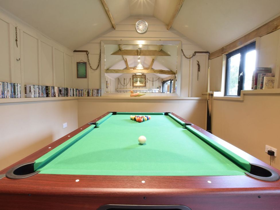 A game room featuring a pool table and a DVD collection at Yew Tree Farm Barn and Stable, Framlingham