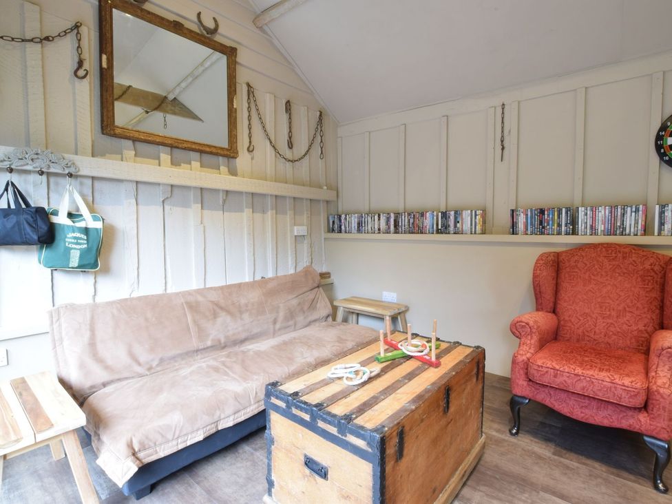 A snug with a sofa and armchair at Yew Tree Farm Barn and Stable Framlingham