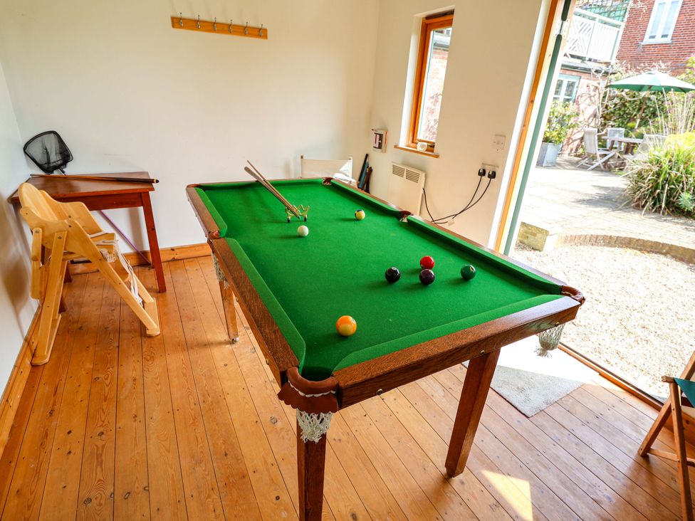 A games room with a pool table and a patio door at Robert Sadler's Studio in Aldeburgh