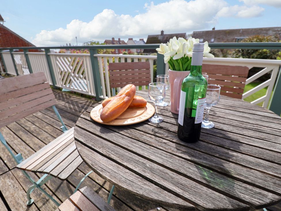 An outdoor seating area with a table and chairs at Robert Sadler's Studio in Aldeburgh
