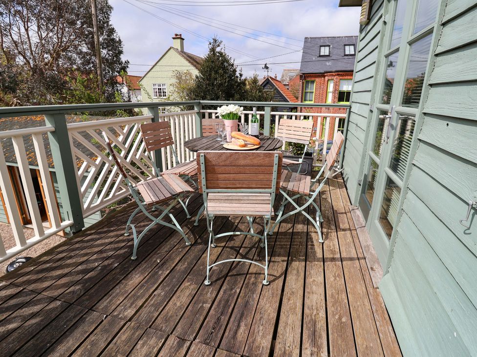 An outdoor deck with a table and chairs at Robert Sadler's Studio in Aldeburgh