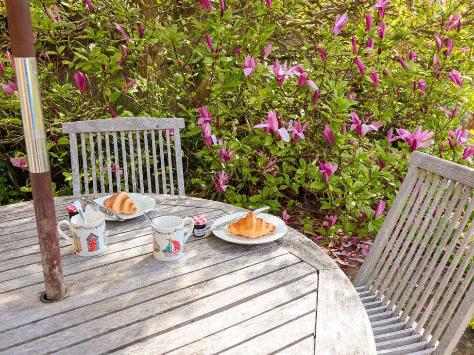 Outdoor seating area with a table and chairs at Robert Sadler's Studio in Aldeburgh
