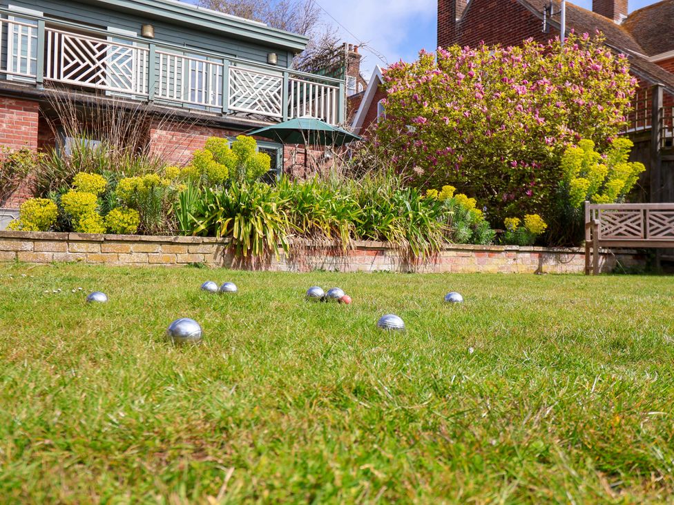 A garden with boules on grass and a deck in Robert Sadler's Studio Aldeburgh