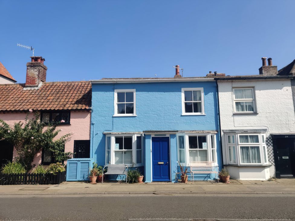 A row of houses with blue and pink facades at Seaflower, Aldeburgh