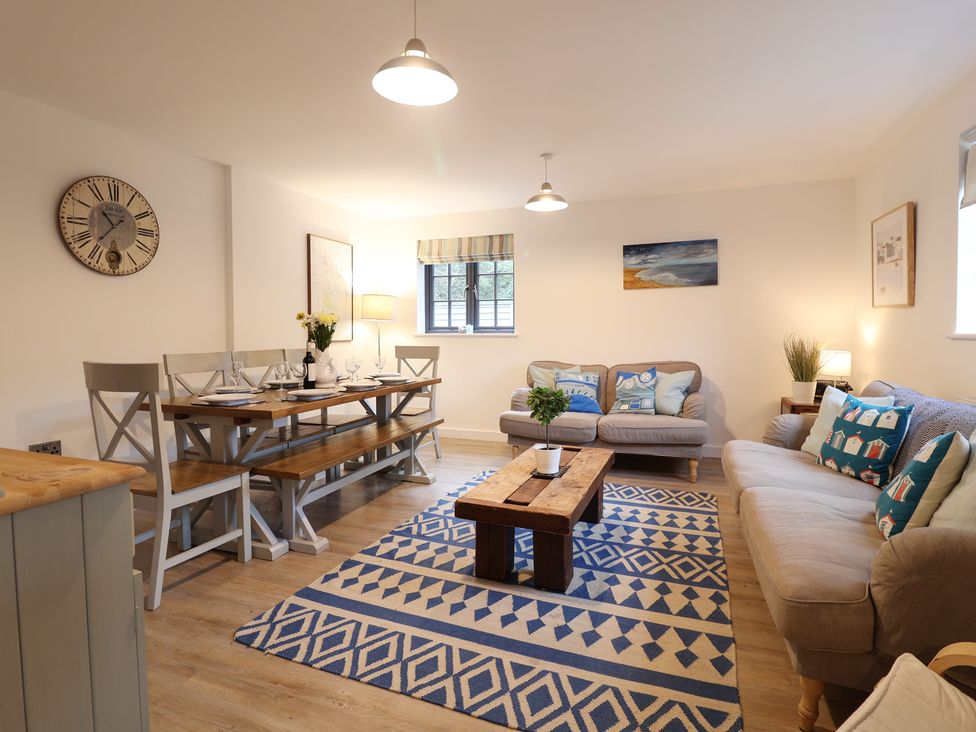 A living room with a dining area and a coffee table at Corner Cottage, Thorpeness
