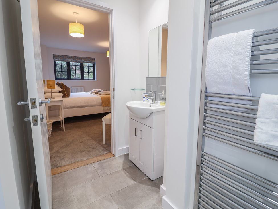 A bathroom with sink and towel rail at Corner Cottage, Thorpeness