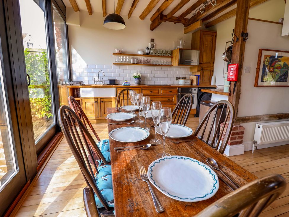 A dining room with a table set for dinner at Fishpond House, Sotherton Halesworth