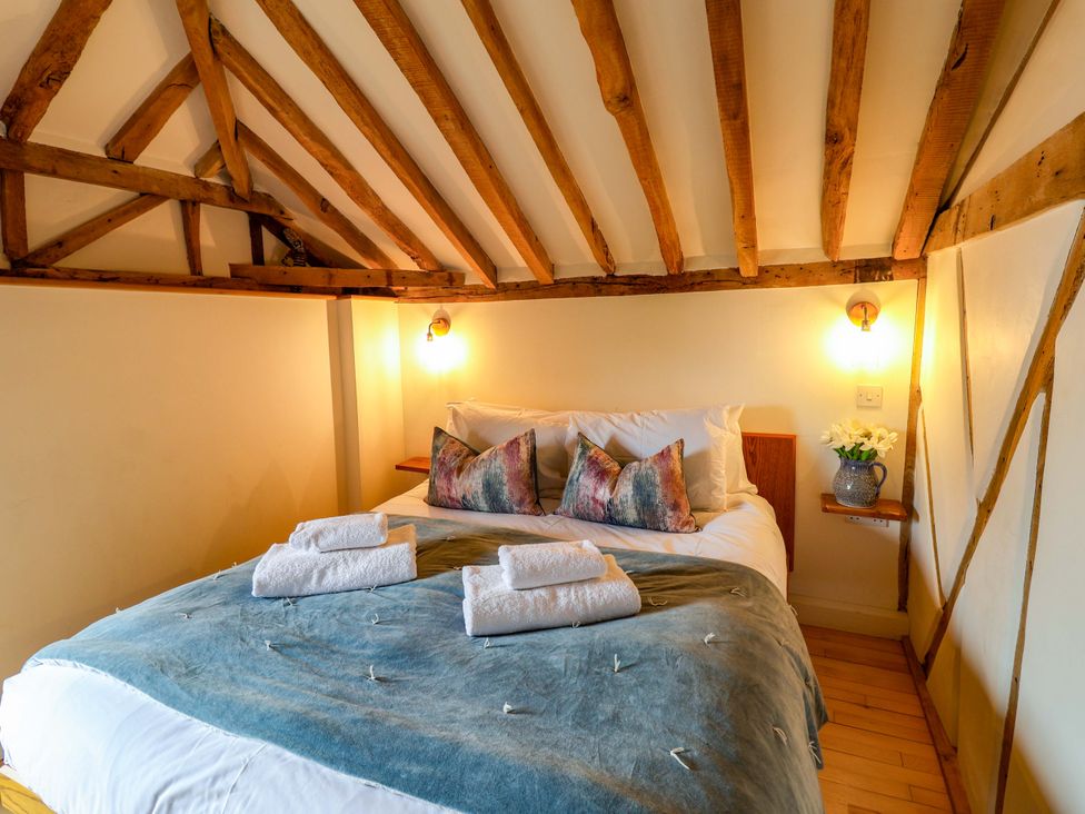 A bedroom with a bed and pillows at Fishpond House, Sotherton Halesworth