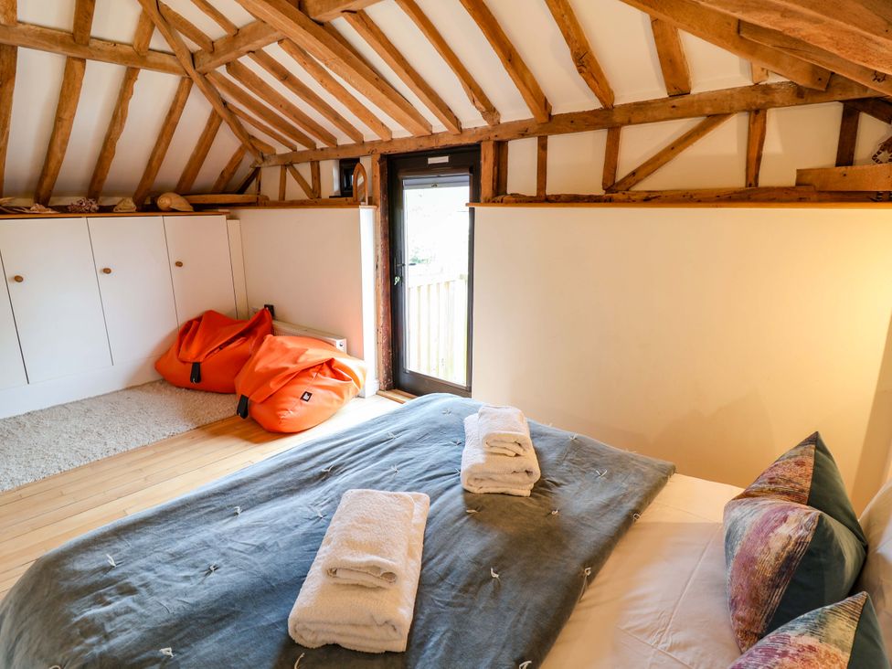 A bedroom with a bed and bean bags at Fishpond House, Sotherton