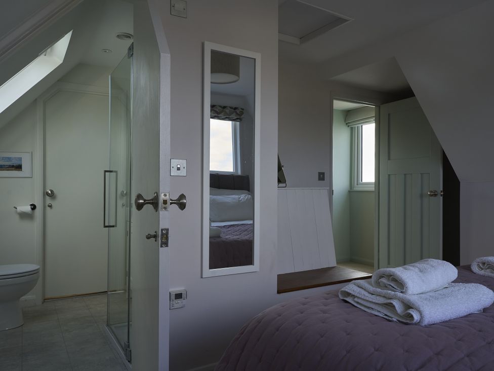 A bathroom with a shower and toilet at Harbour Lights in Southwold