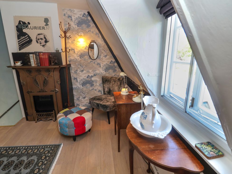 A sitting room with a fireplace and furniture at Cherry Tree Cottage, Woodbridge