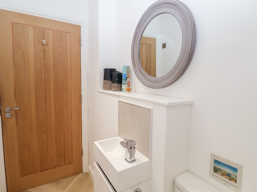 A bathroom with a sink and mirror at Salt Marsh House, Southwold