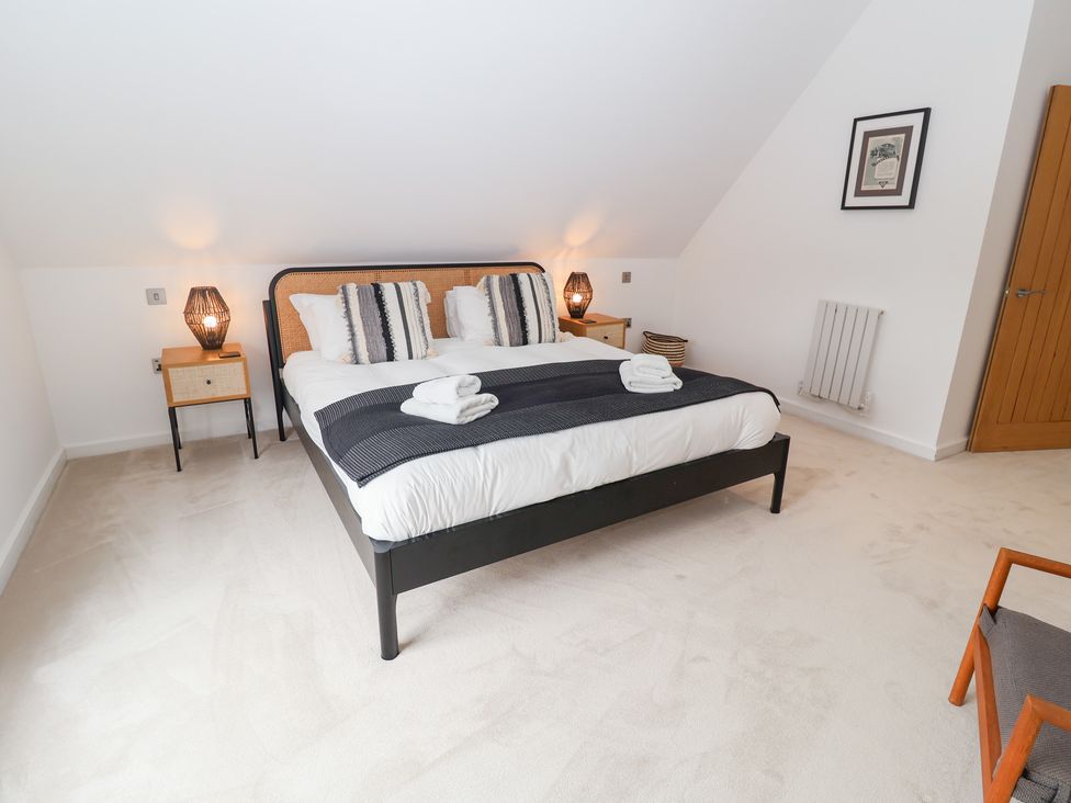 A bedroom with a double bed and bedside tables at Salt Marsh House, Southwold
