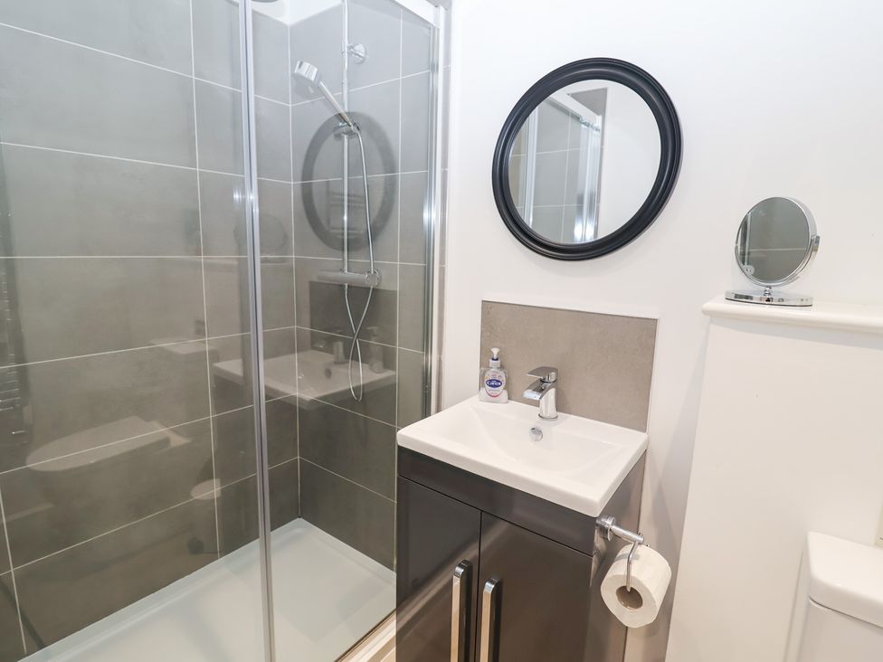 A bathroom with a shower and sink at Salt Marsh House, Southwold