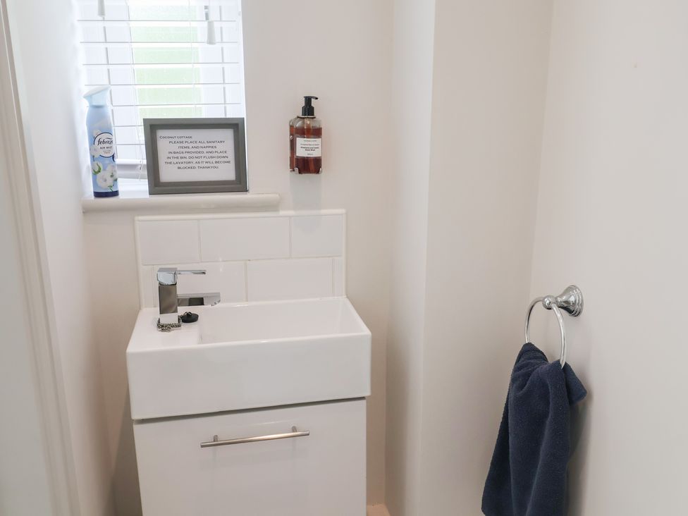 A bathroom with a sink and towel in 1 Coconut Cottage, Long Melford