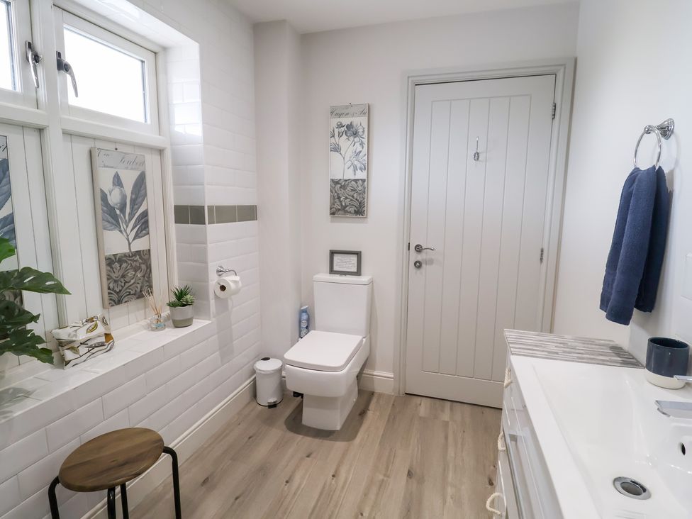 A bathroom with a toilet and sink at 1 Coconut Cottage, Long Melford
