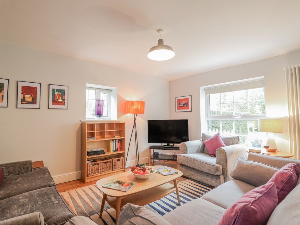 A living room with a sofa and coffee table at Fig Cottage, Pettistree Near Woodbridge
