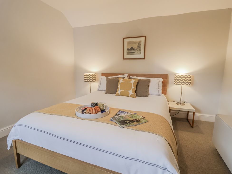A bedroom with a bed and side tables at Fig Cottage, Pettistree Near Woodbridge