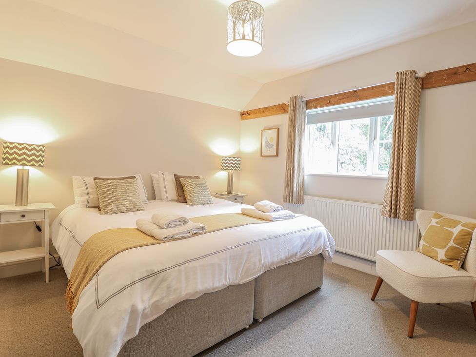 A bedroom with a double bed and two lamps at Fig Cottage, Pettistree Near Woodbridge