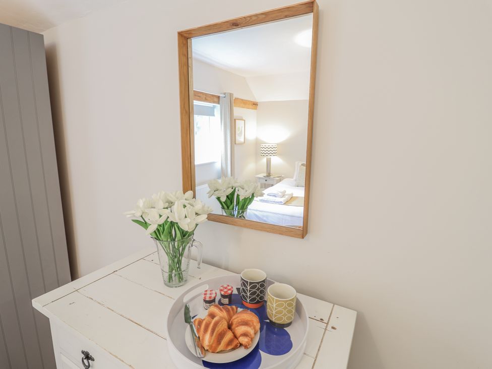 A tray with croissants and cups on a white chest at Fig Cottage, Pettistree