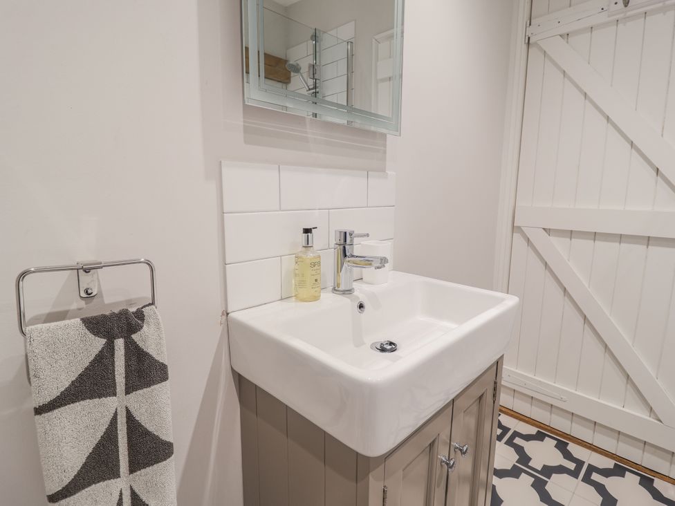 A bathroom with a sink and mirror at Fig Cottage, Pettistree Near Woodbridge