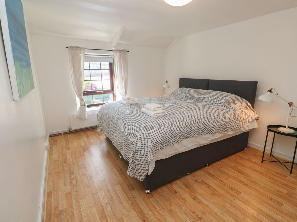 A bedroom with a bed and window at Candle Croft in Tolgus Mount near Redruth