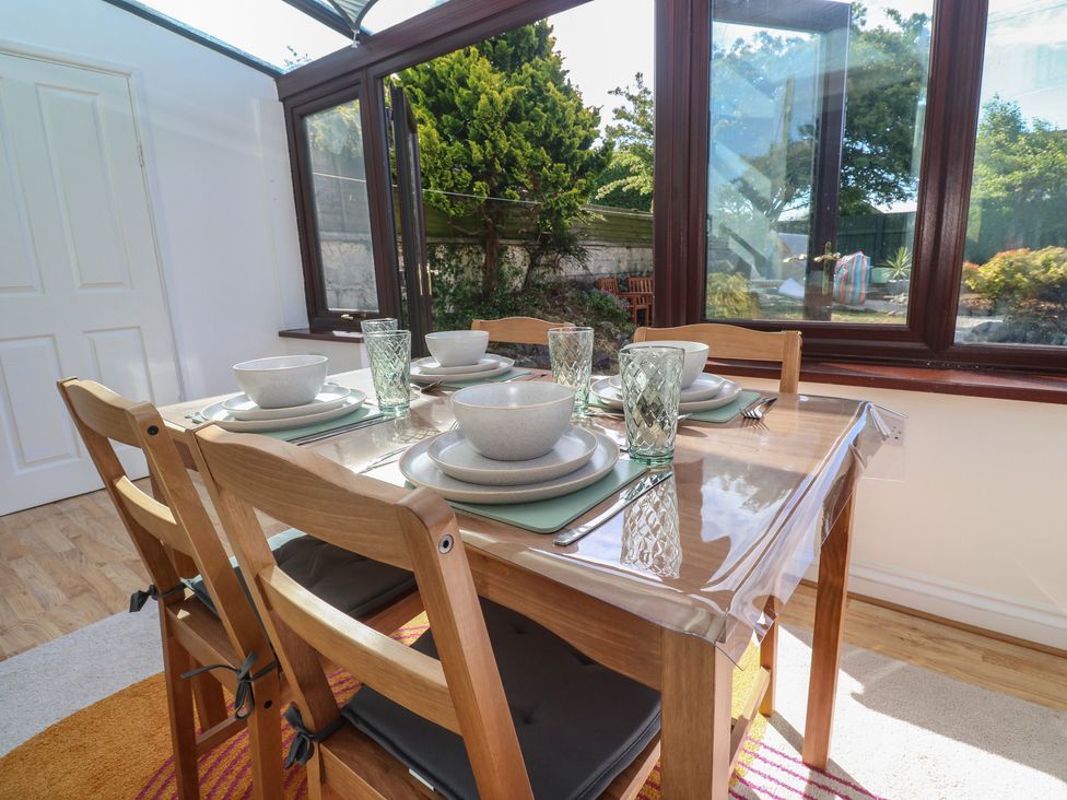 A dining room with a table set for four at Candle Croft near Tolgus Mount