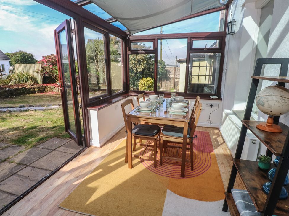 A conservatory with a dining table set at Candle Croft in Tolgus Mount near Redruth