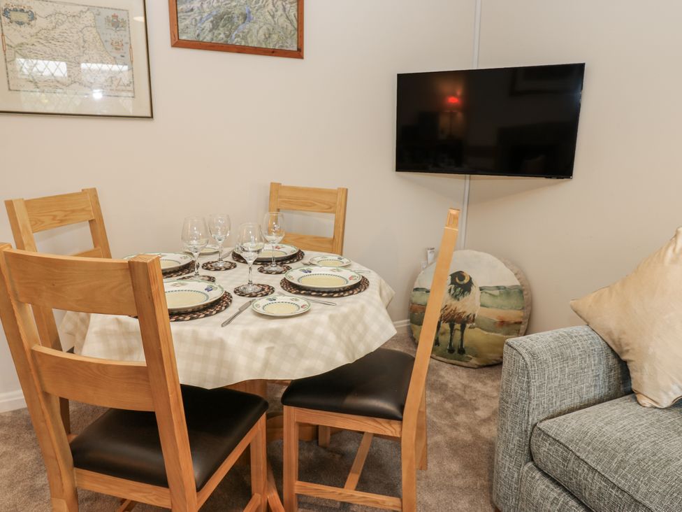 A dining table set with plates and glassware at Appletree Cottage in Richmond