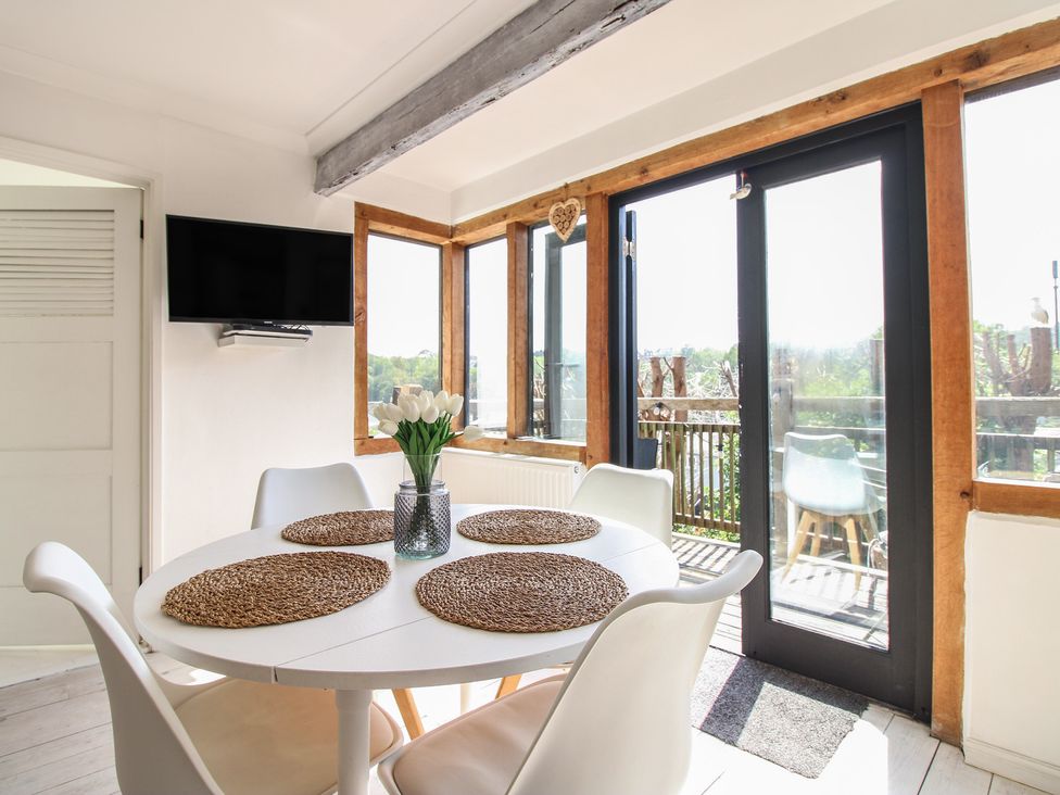 A dining room with a table and chairs at West Island in Kingsbridge