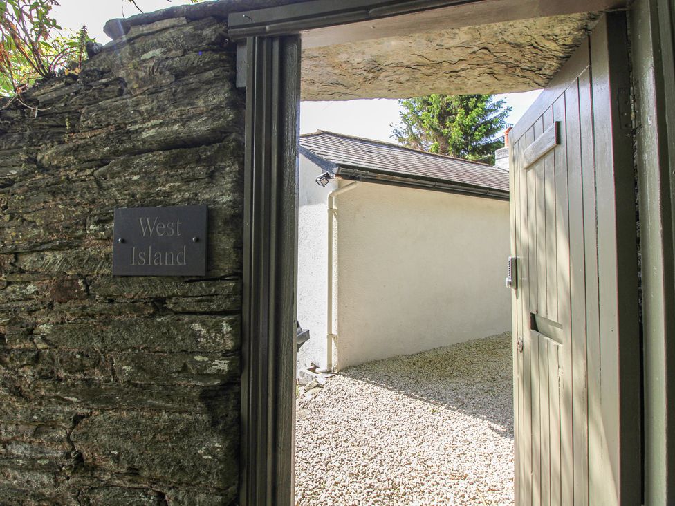 An entrance with a gate and stone wall at West Island in Kingsbridge