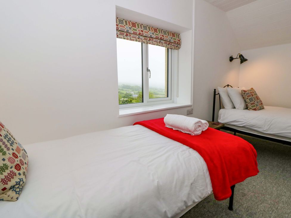 A bedroom with two beds and a window at Ceunant near Newport