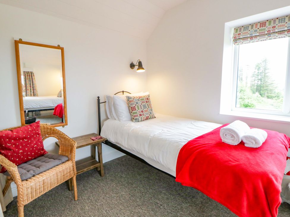 A bedroom with a single bed and chair at Ceunant near Newport