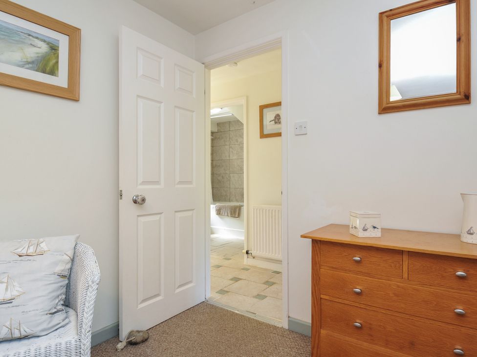A bathroom with a door leading to another room at The Mews in Blisland