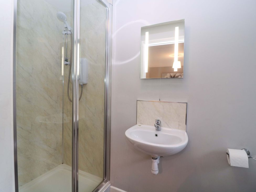A bathroom with a shower and sink at Sunny Cottage in Brecon