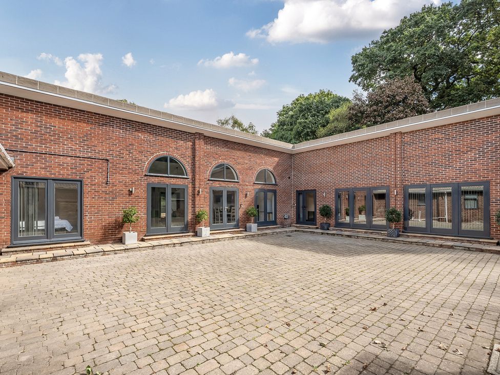 An outdoor area with brick walls, windows, and paved flooring at The Annex Wimborne Minster