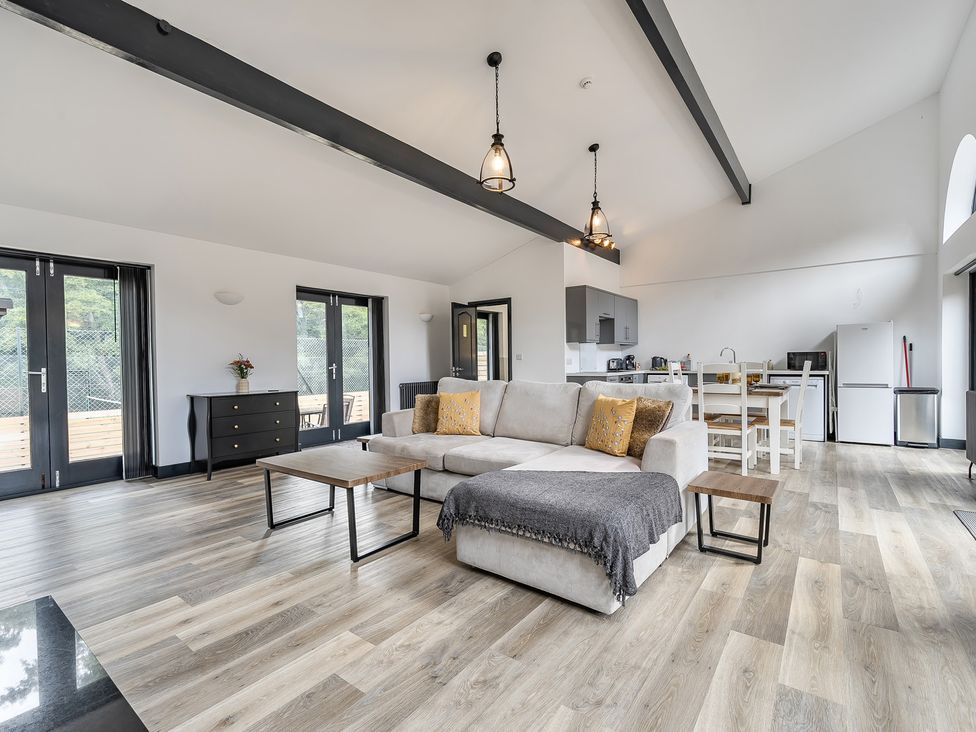A living room with a sofa and dining area at The Annex in Wimborne Minster