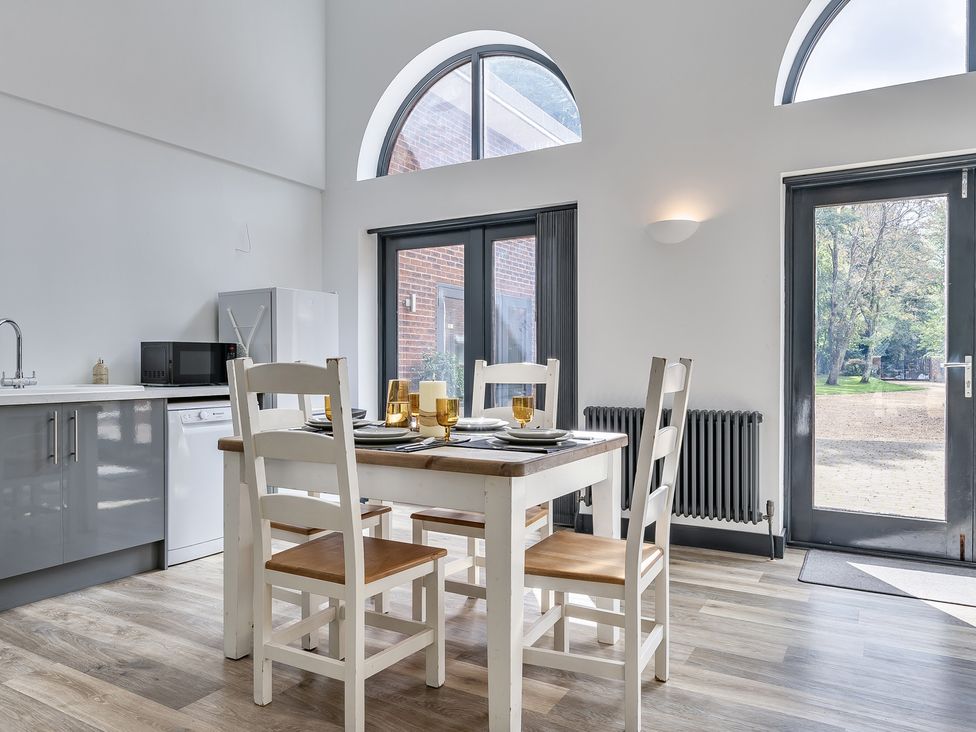 A kitchen with a table and chairs at The Annex in Wimborne Minster
