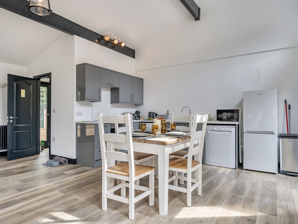 A kitchen with a table and chairs at The Annex in Wimborne Minster