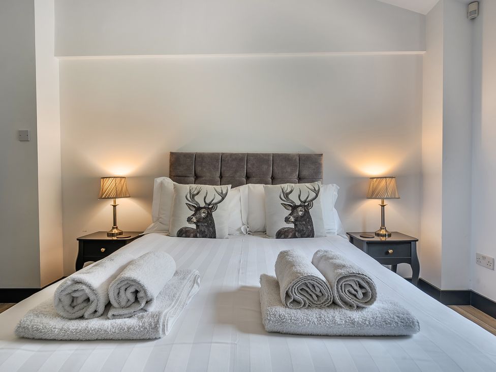 A bedroom with a bed and pillows at The Annex in Wimborne Minster