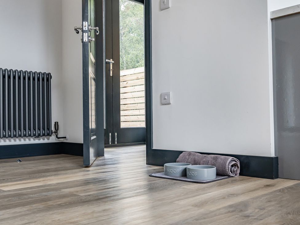 A room with a radiator and dog bowls at The Annex Wimborne Minster